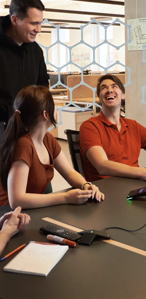 Team members have a happy discussion during an office meeting