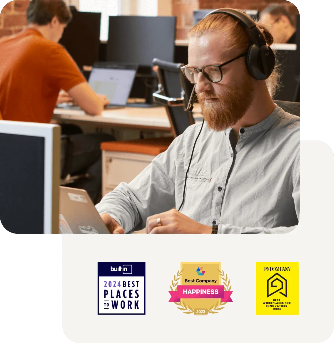 A man confidently working at his desk