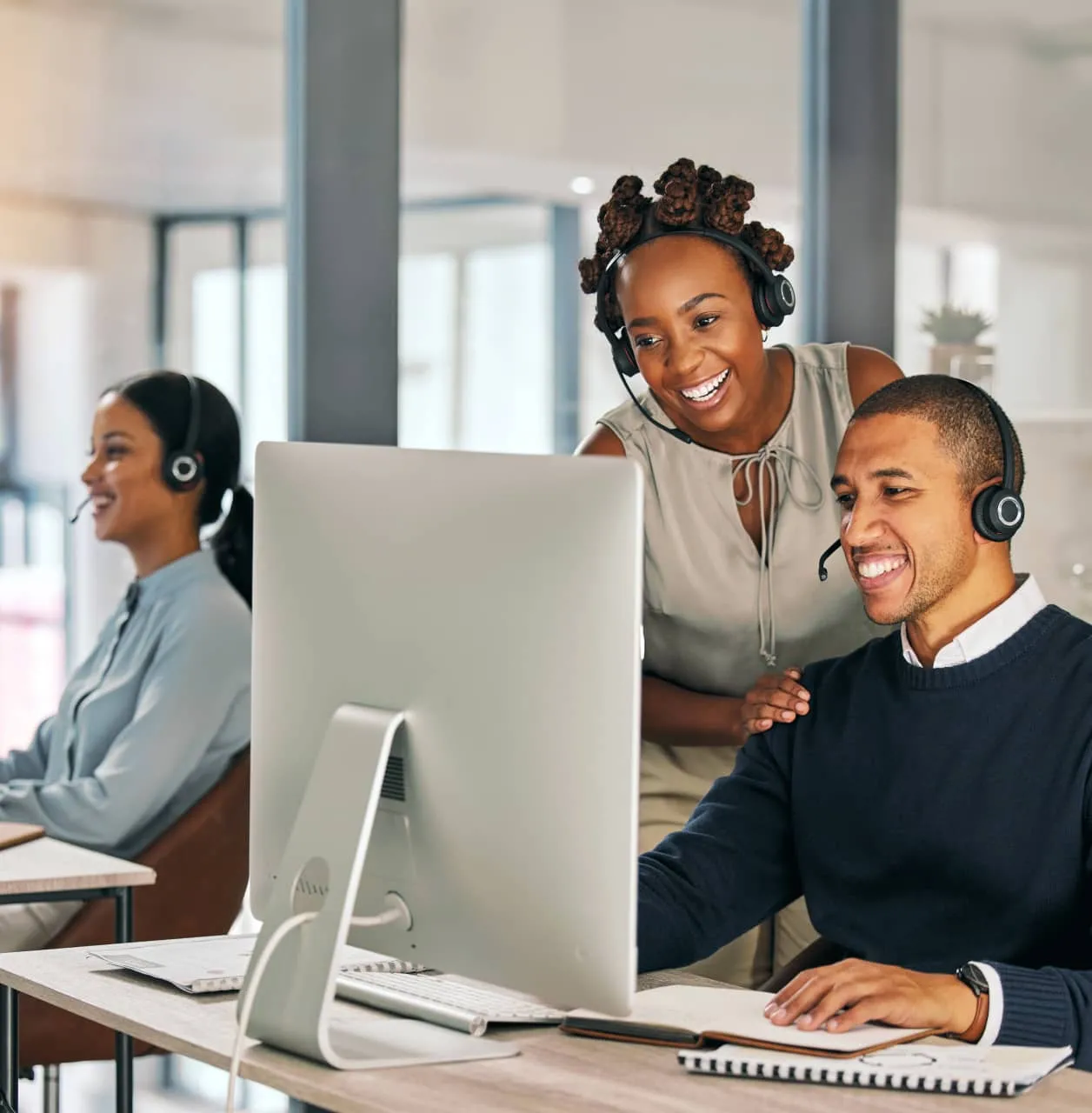 A group of contact center agents working in the office