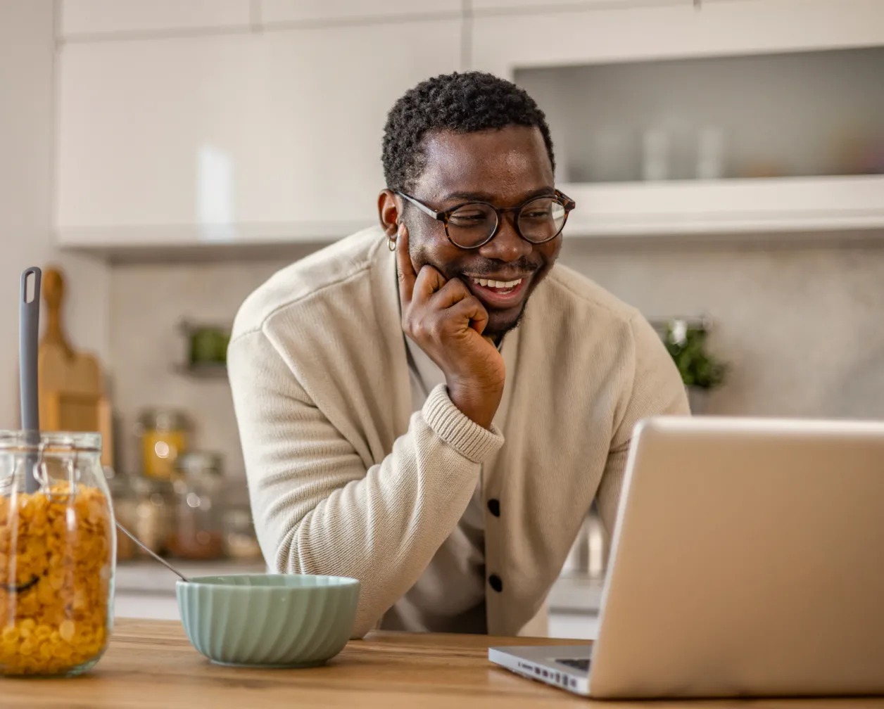 A man working from home using his laptop to join a meeting about his remote volunteering activities