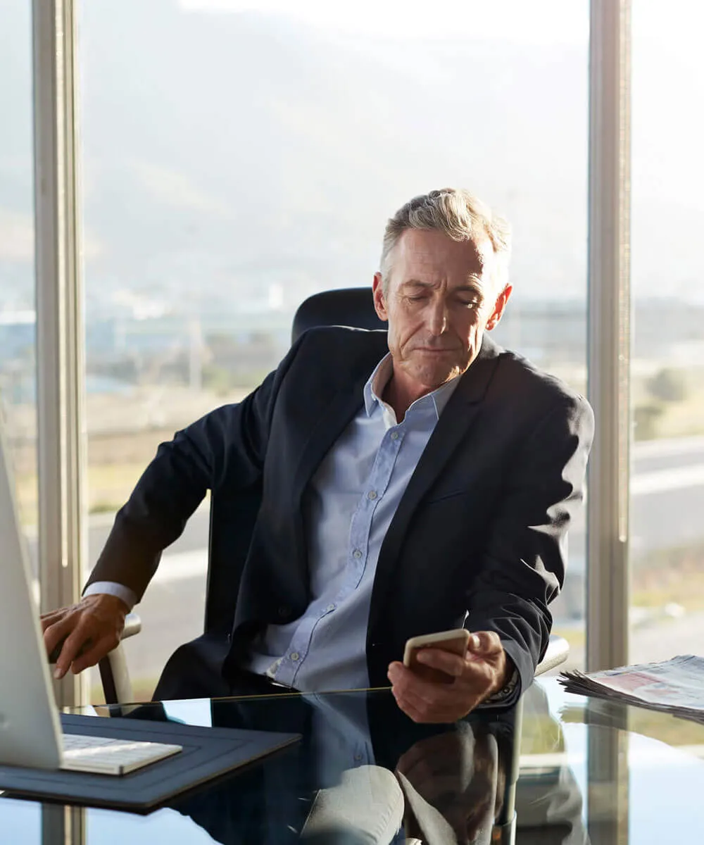 A corporate employee using virtual phone system platform on desktop and mobile