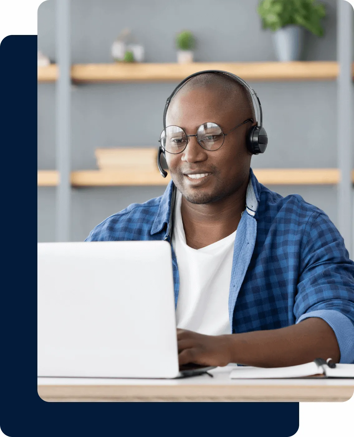a man wearing a headset look at his laptop