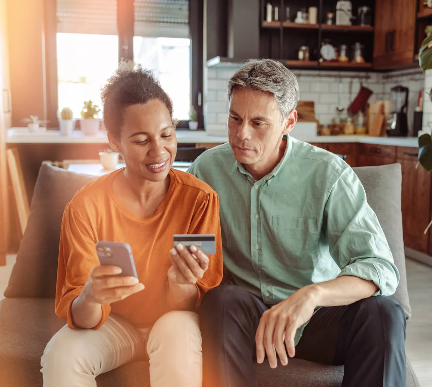 A woman using her mobile phone to activate a credit card