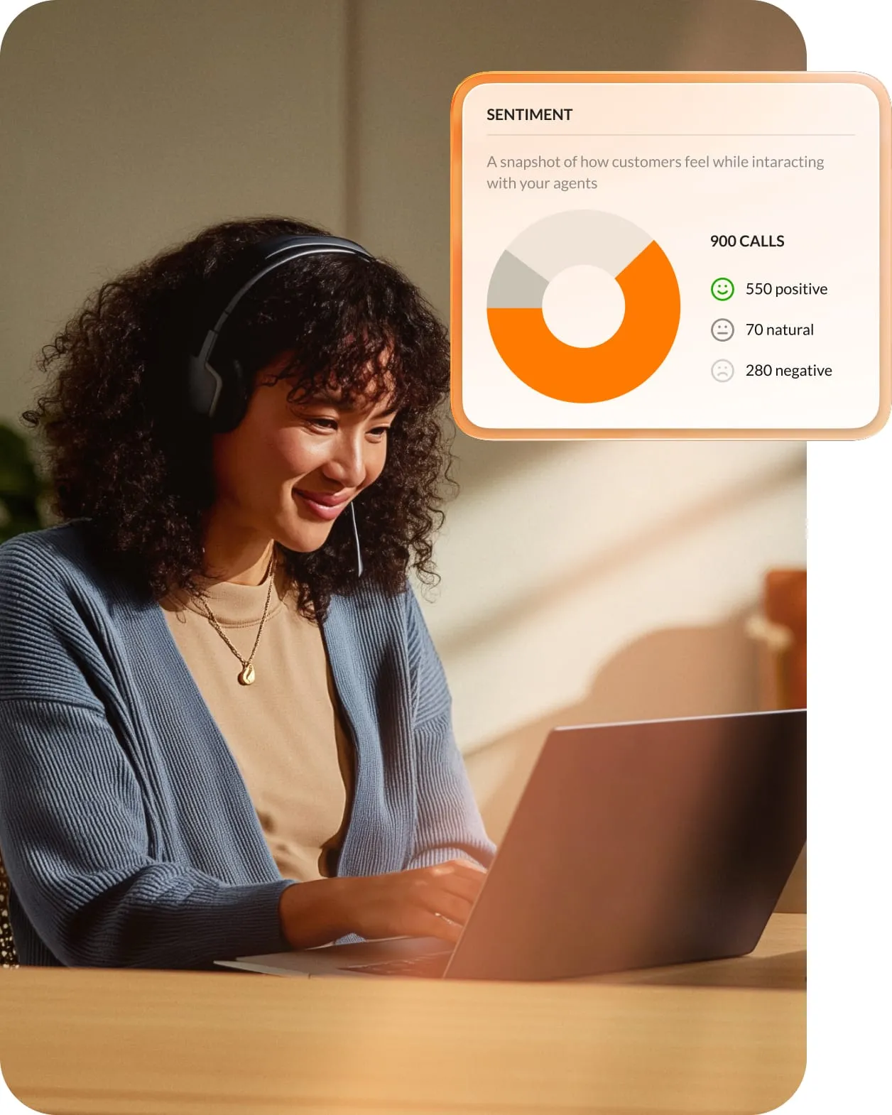 A call center worker is smiling while reviewing RingCentral Sentiment scores for her staff