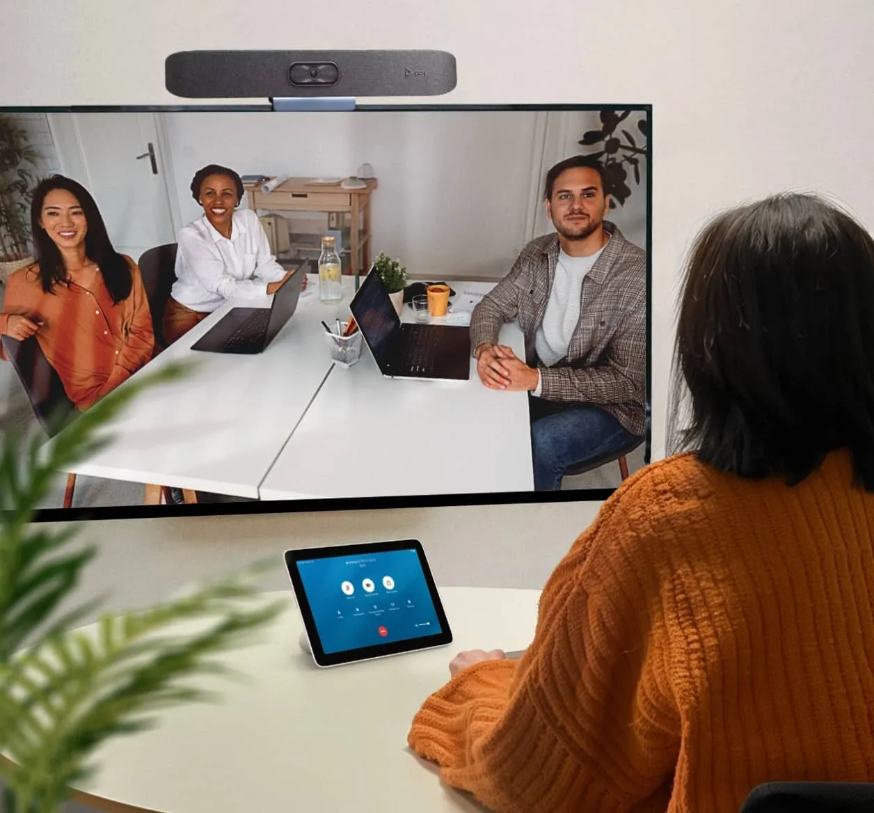 A woman joins an ongoing virtual meeting with colleagues via RingCentral Rooms