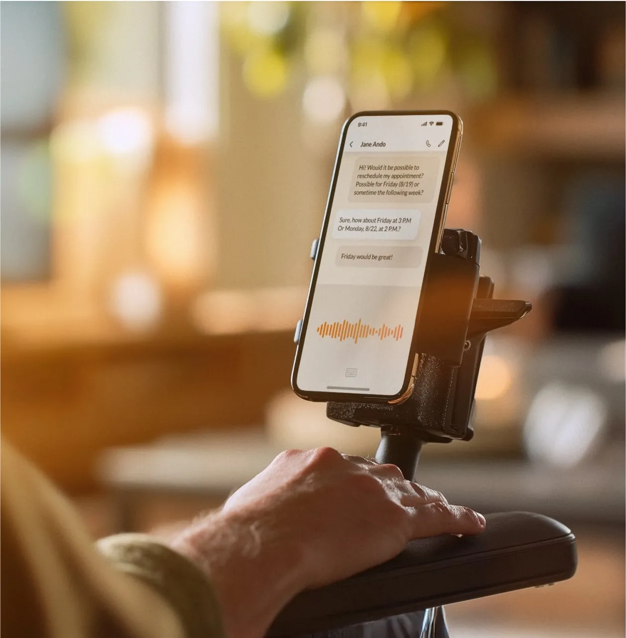 A person uses voice-to-text in the RingCentral app with the smartphone mounted on a stand.
